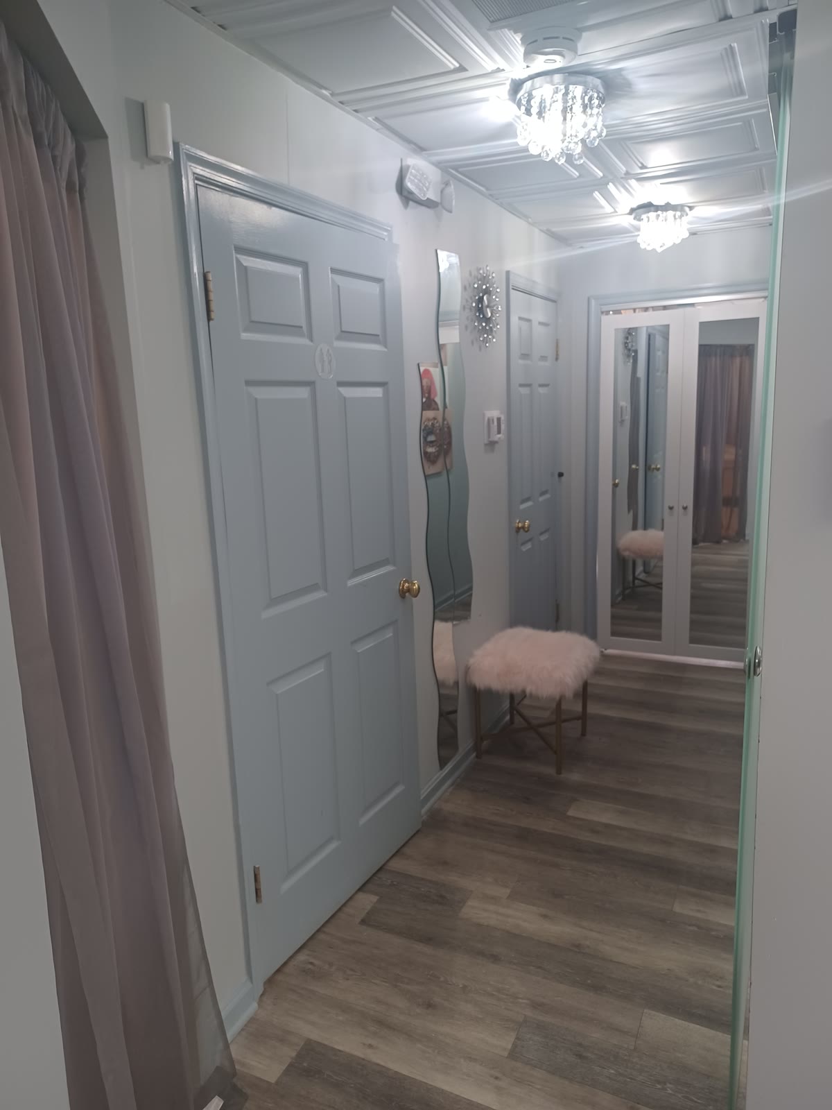 Bright salon interior with elegant doors, mirrored accents, and chic decor